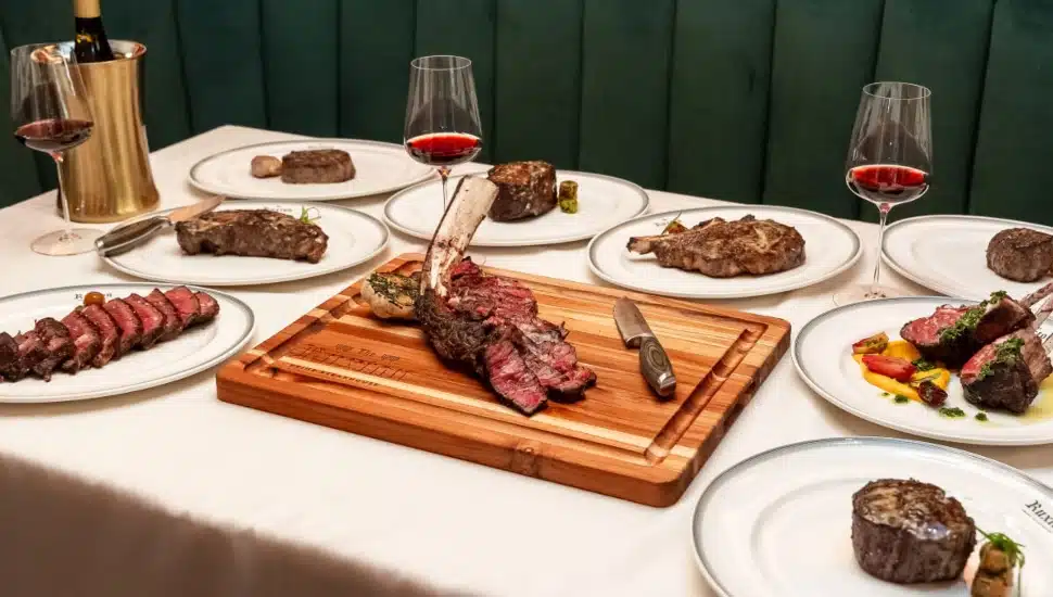 Steak and wine on a table outside The Ruxton.