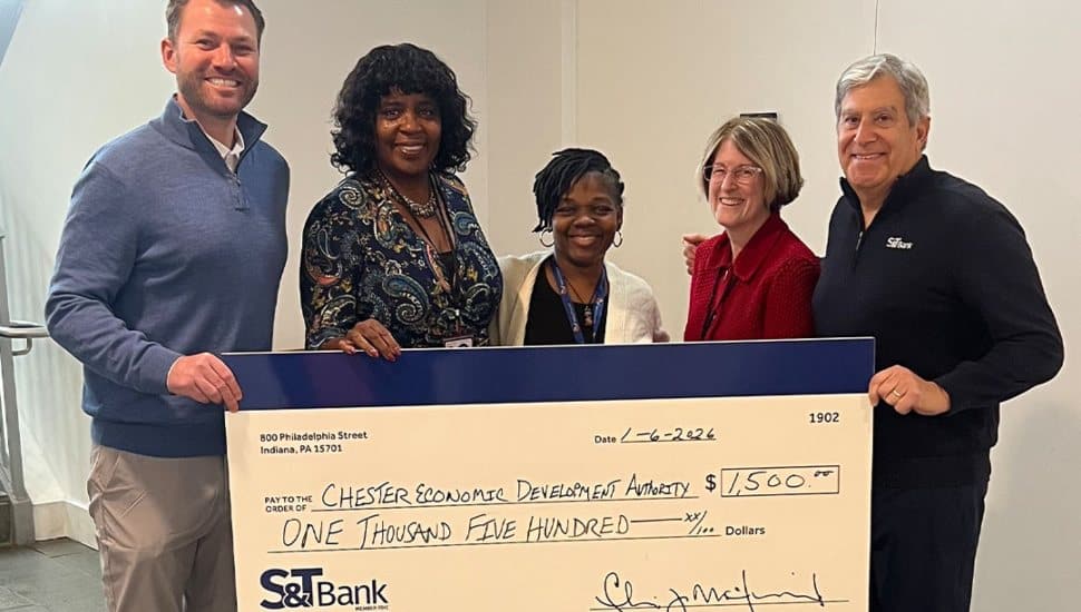 S&T Bank representatives present a $1,500 donation to the Chester Economic Development Authority to support affordable housing and community development efforts in Chester.