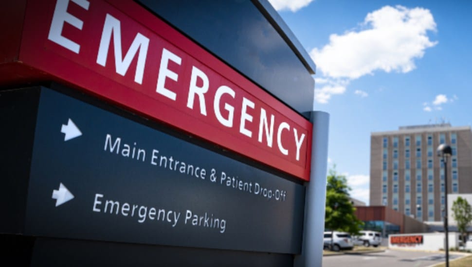 A red signs guides drivers toward the Emergency Room.