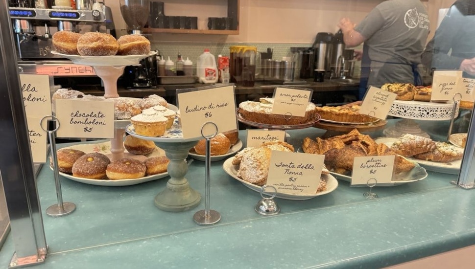 Various desserts and pastries at a window.