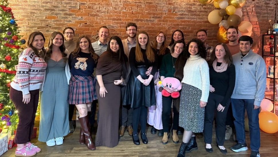 Staff of digital marketing agency take group picture.