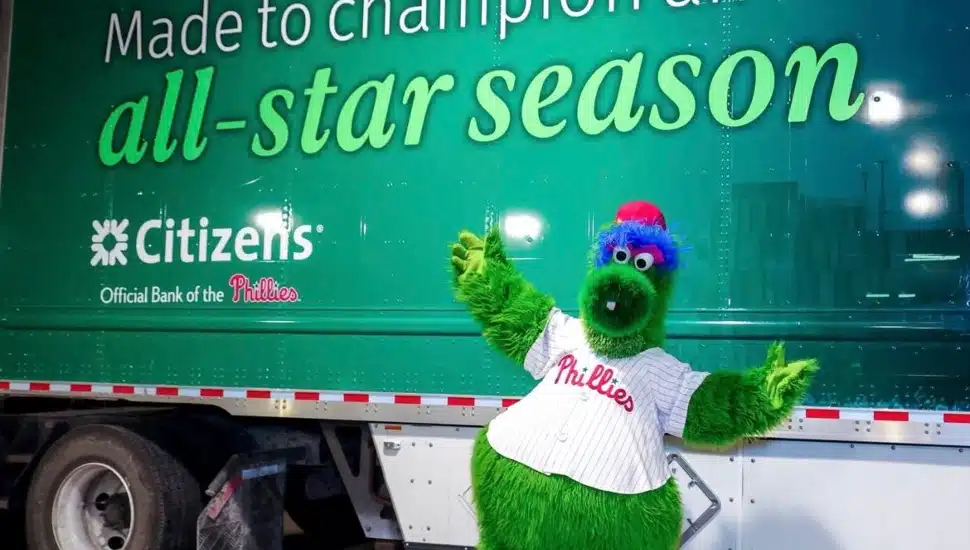 Phillie Phanatic posing in front of Phillies truck.