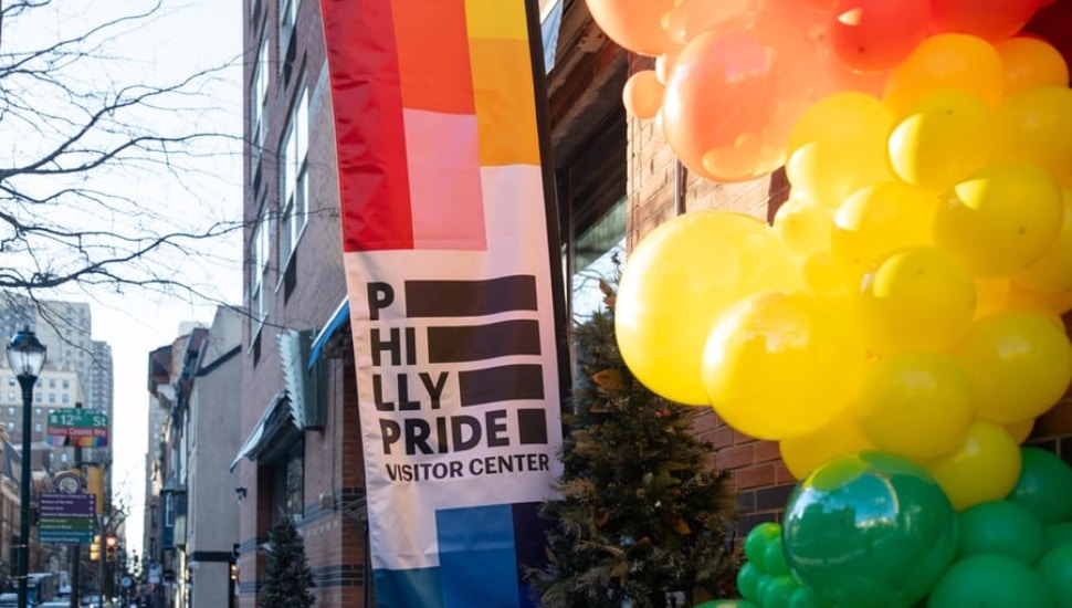 Philly Pride Visitor Center celebration with balloons.