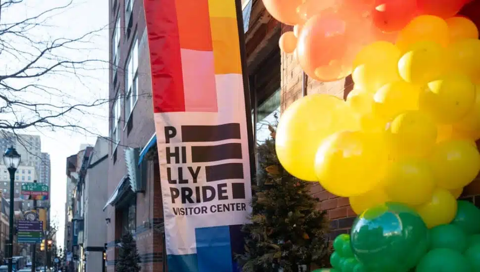Philly Pride Visitor Center celebration with balloons.