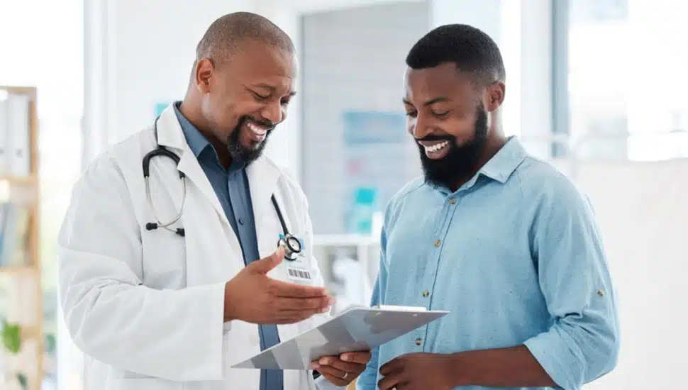 Male doctor consults with male patient.