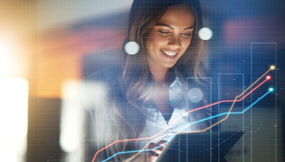 Businesswoman looks at the stock market on a tablet.