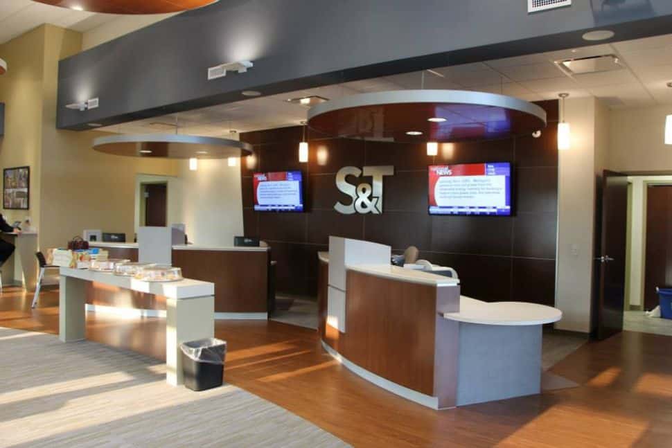 Inside of an S&T Bank branch location. Clean, open concept with banking stations.