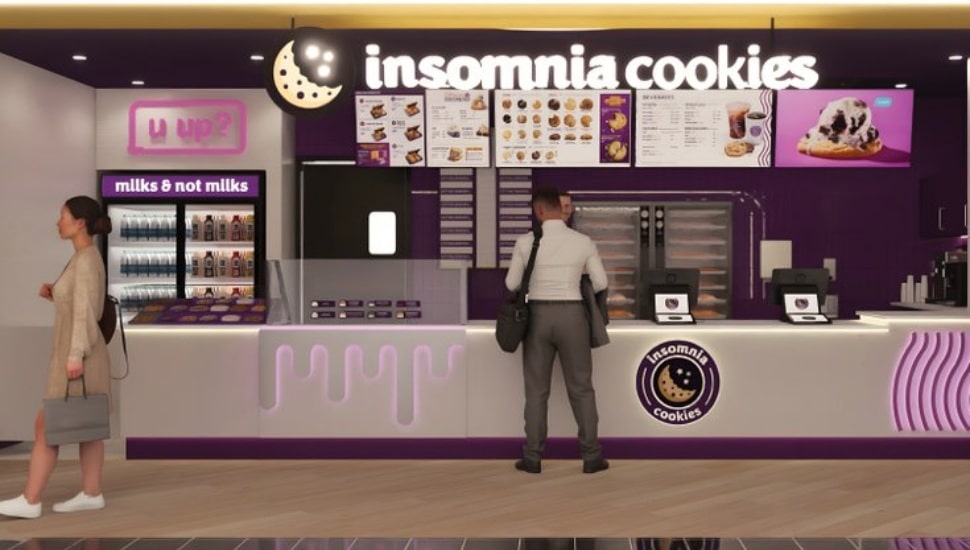 An Insomnia Cookies counter with a customer.