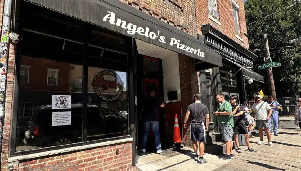 A line of customers outside Angelo's Pizzeria.