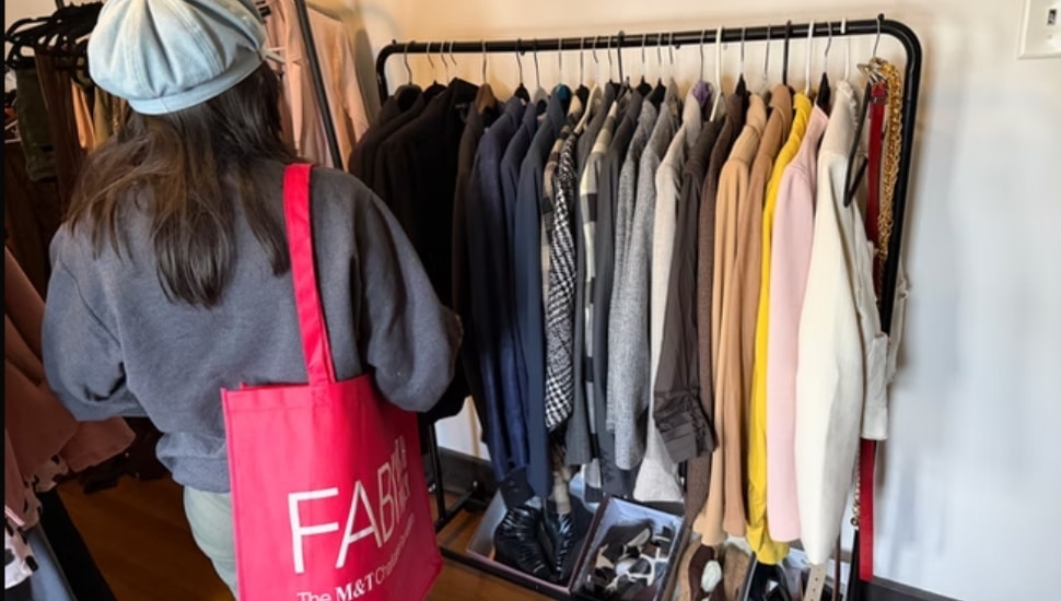 A shopper inside FAB FITS looking at various outfits.