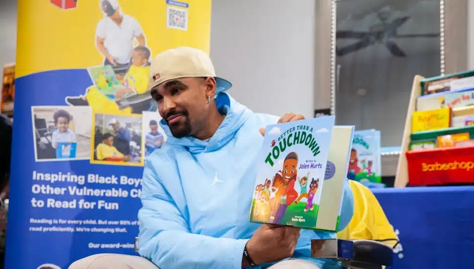 Jalen Hurt holding his new children's book.