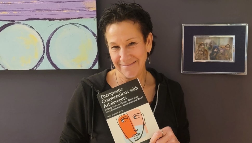 Middle-aged woman holds her book.