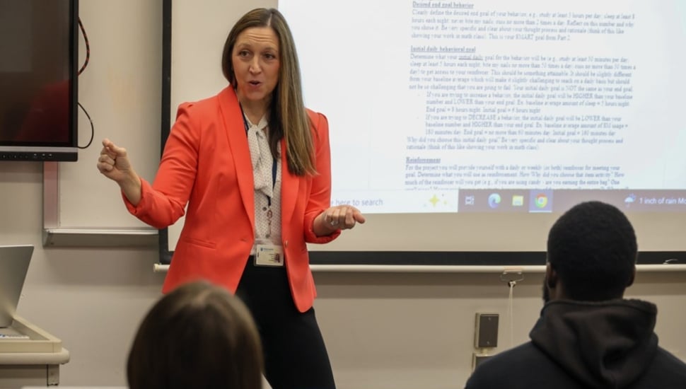 College professor teaches class.