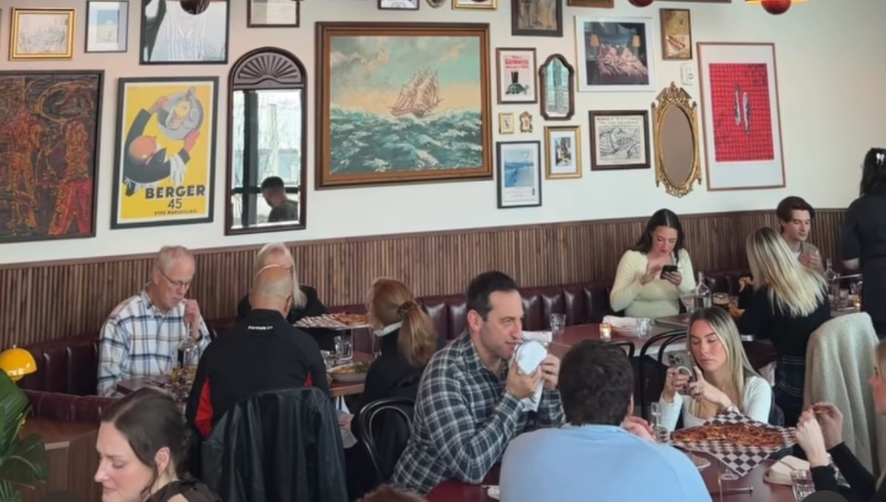 Customers enjoying food and drinks inside Lucky Duck.