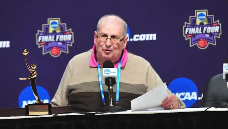 Mel Greenberg sitting at a podium.