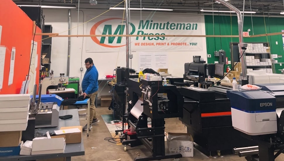 A man working inside Minuteman Press in Philadelphia.