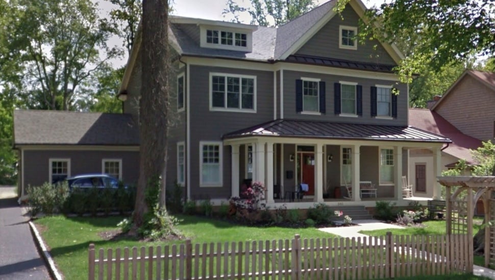 Exterior view of single-family home with tree in front yard.