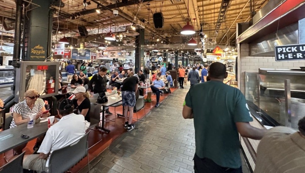 People ordering and eating food inside Reading Terminal Market.