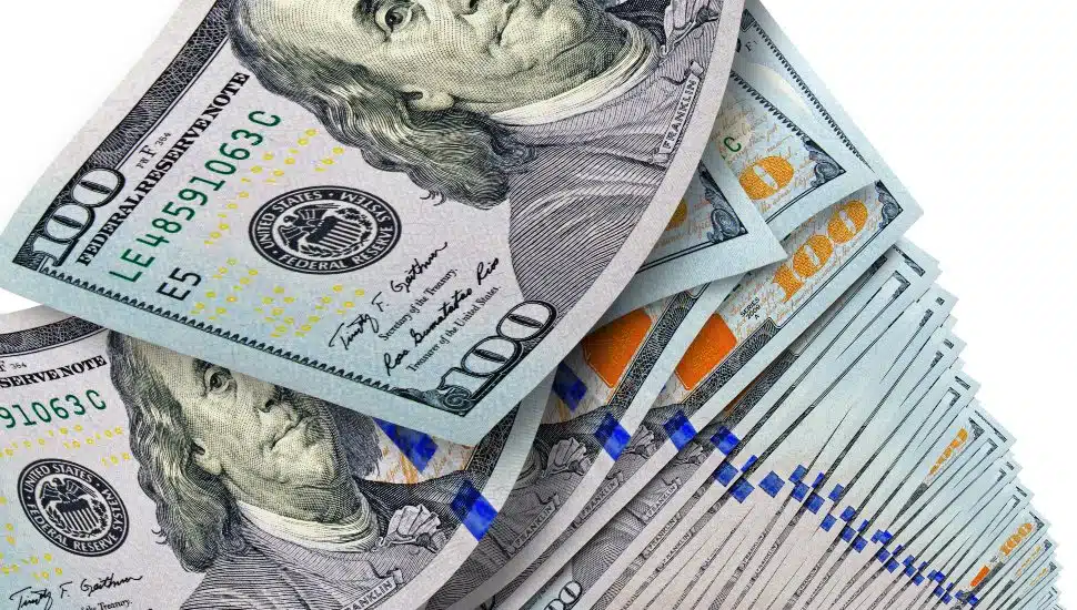 Very large stack of hundred-dollar bills on a white background.