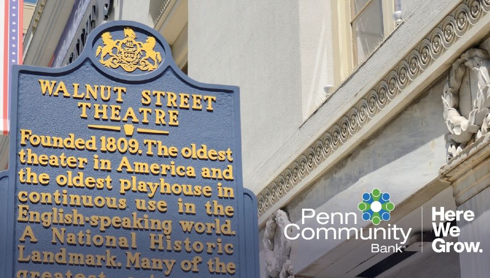 Historical marker for Walnut Street Theatre, America’s oldest continuously operating theatre, displayed beside the theatre’s exterior facade with Penn Community Bank branding overlay.