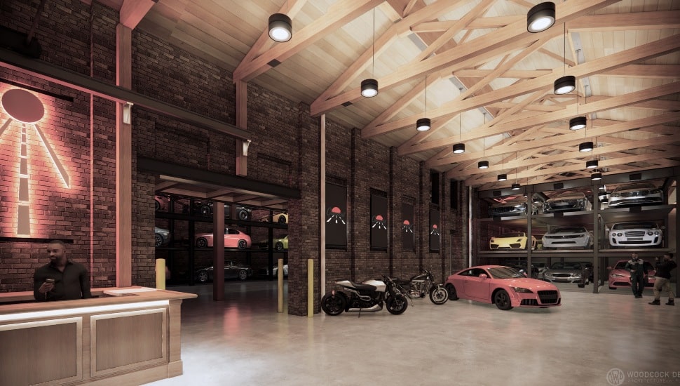 Inside Cannonball Club storage space with people and cars.