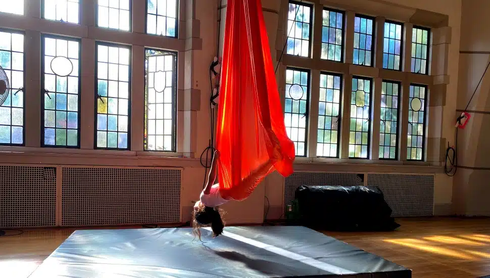 A young woman performing a circus arts routine.