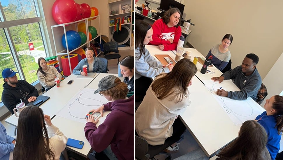 College students work in small groups at tables.