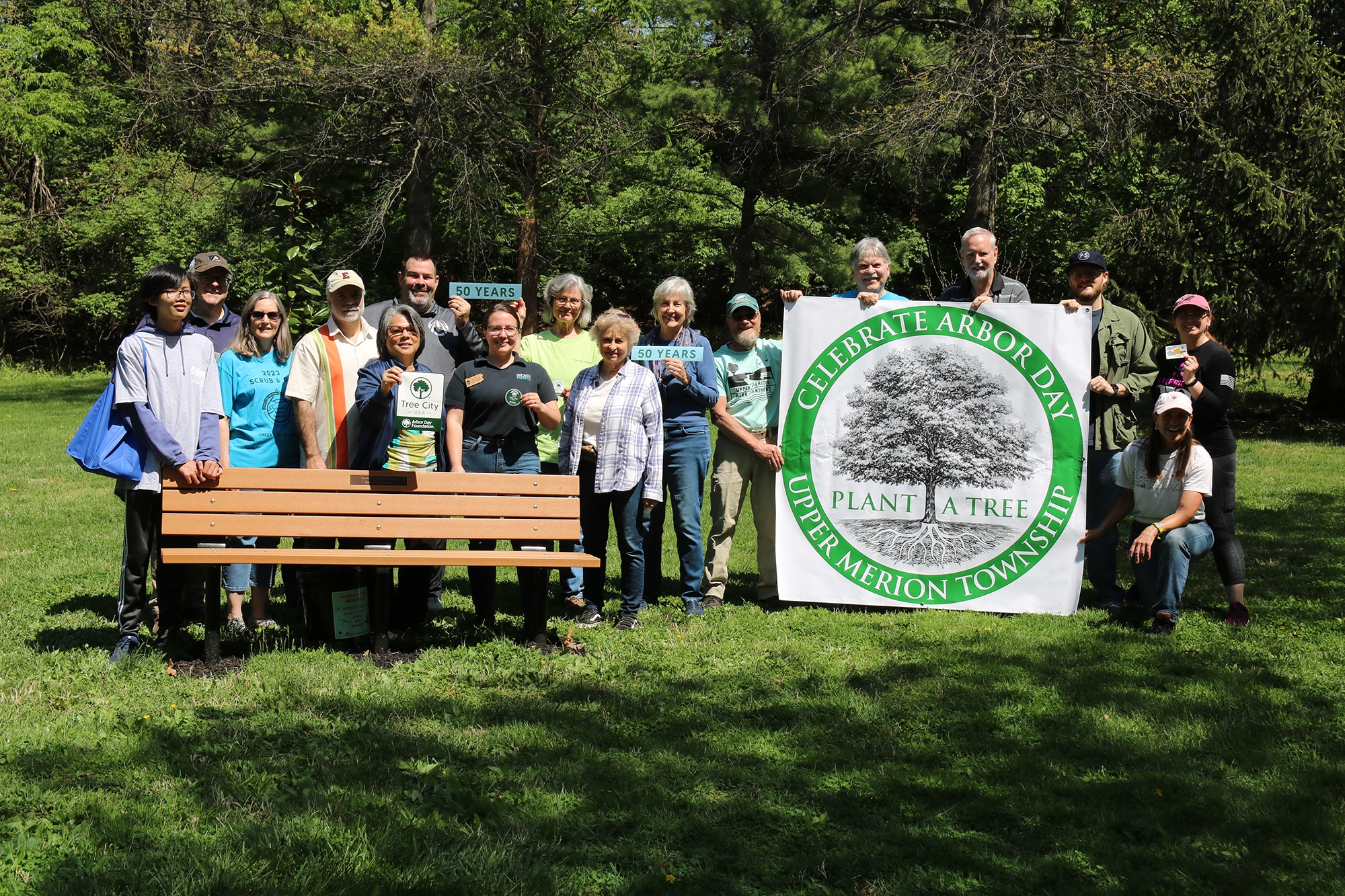 A group gathers at the General Recreation park bench celebrating Upper Merion's 50th year as a Tree City USA reward recipient and the nation's 250th anniversary.