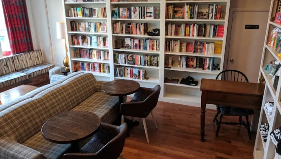 Interior of Uncle Bobbie's Coffee & Books with book cases, a couch, table, and chairs.