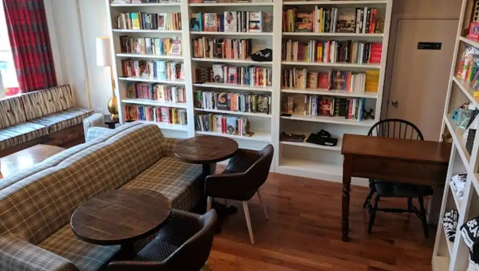 Interior of Uncle Bobbie's Coffee & Books with book cases, a couch, table, and chairs.