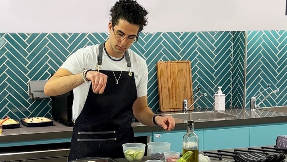 Saif Manna sprinkling a spice.