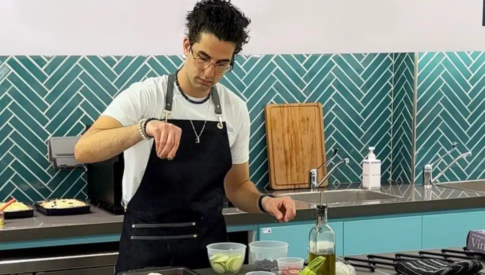 Saif Manna sprinkling a spice.