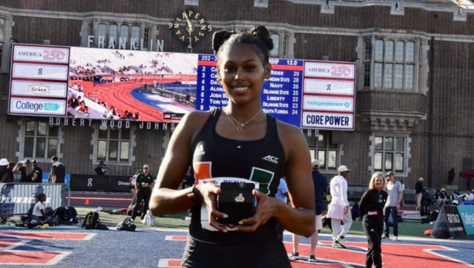 Sanaa Hebron holding Penn Relays trophy.