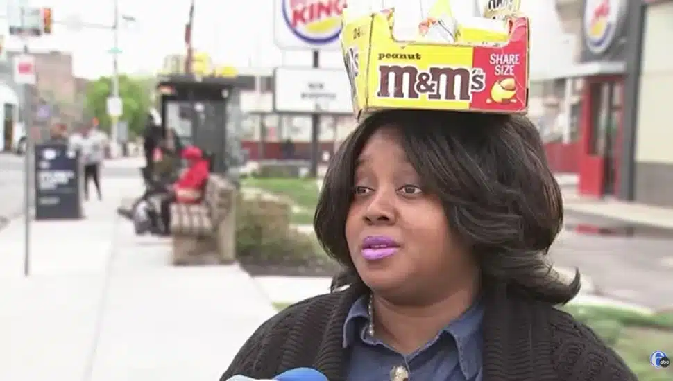 The Candy Lady with a box of candy balancing on her head.