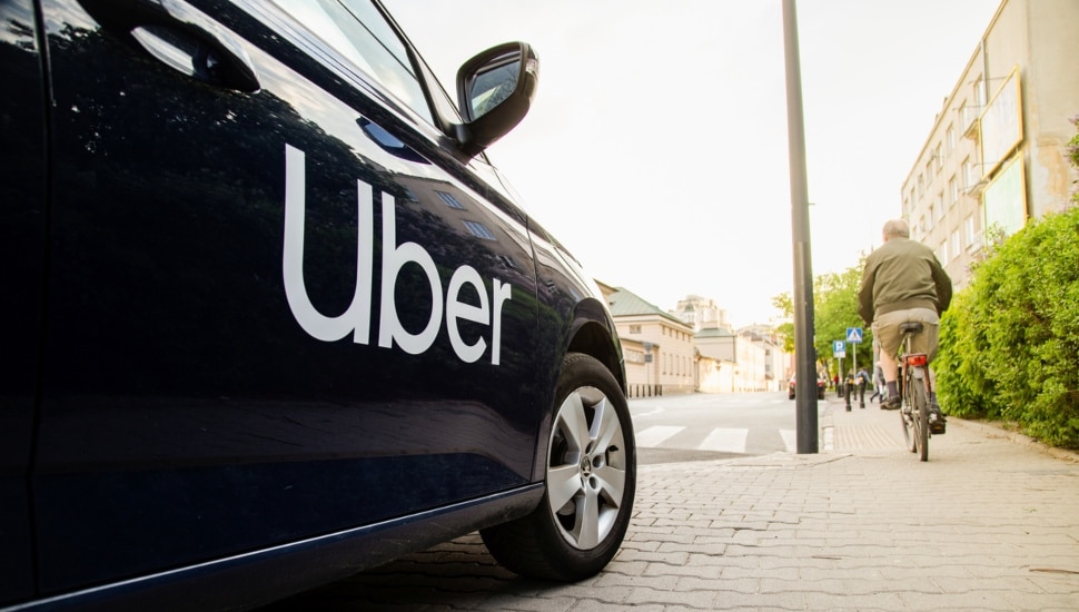 A black car with "Uber" plastered on it.