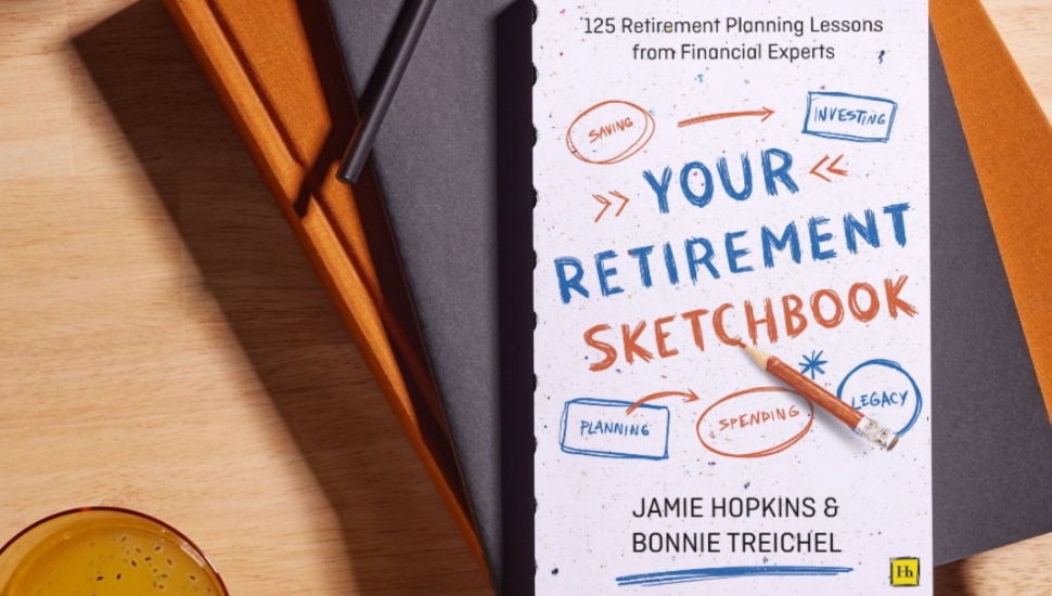 Retirement planning book sits on table next to drink.