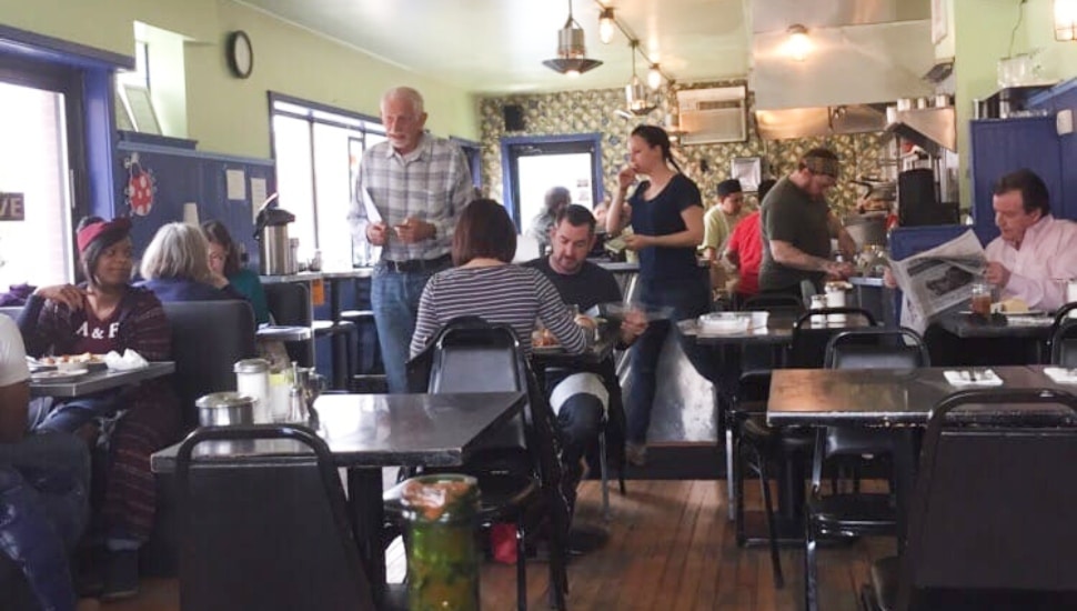 Diners and staff fill the bustling interior of Morning Glory Diner in Philadelphia's Bella Vista neighborhood.