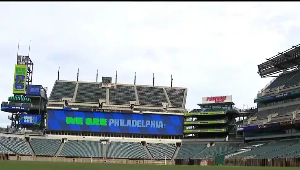 Lincoln Financial Field interior showing FIFA World Cup 2026 "We Are Philadelphia" branding on the stadium scoreboard with freshly laid pitch visible.