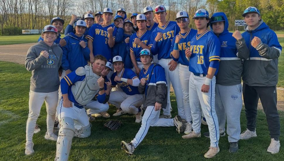 Downingtown West's Whippets team in blue uniforms on baseball field.