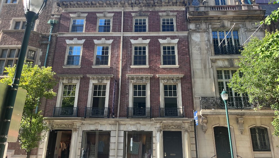 Exterior facade of the Edward C. Knight Mansion at 1629 Locust Street in Philadelphia, a five-story red brick Gilded Age townhouse featuring ornate wrought-iron balconies and stone detailing, designed by architect Horace Trumbauer in 1902.