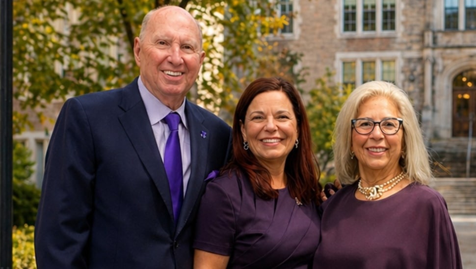 College professor poses for picture with two philanthropists.