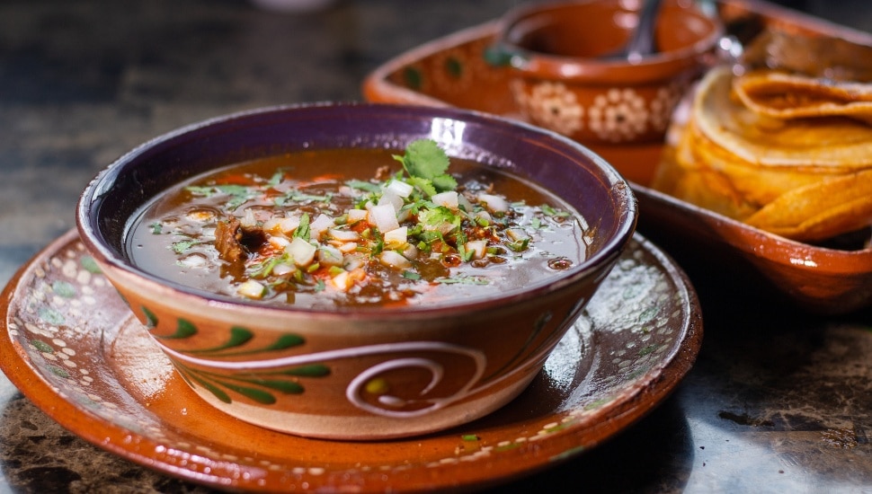 Traditional Mexican dish with beef birria with red sauce.