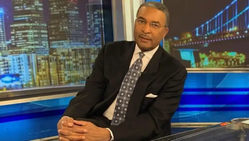 Ukee Washington sits behind his anchor desk at CBS News.