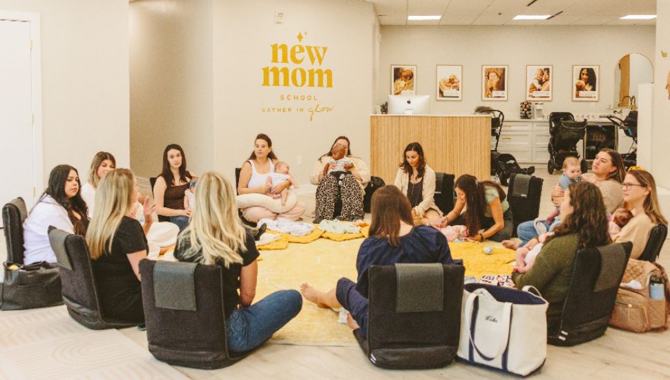 Group of mothers and babies sitting in a circle at New Mom School.